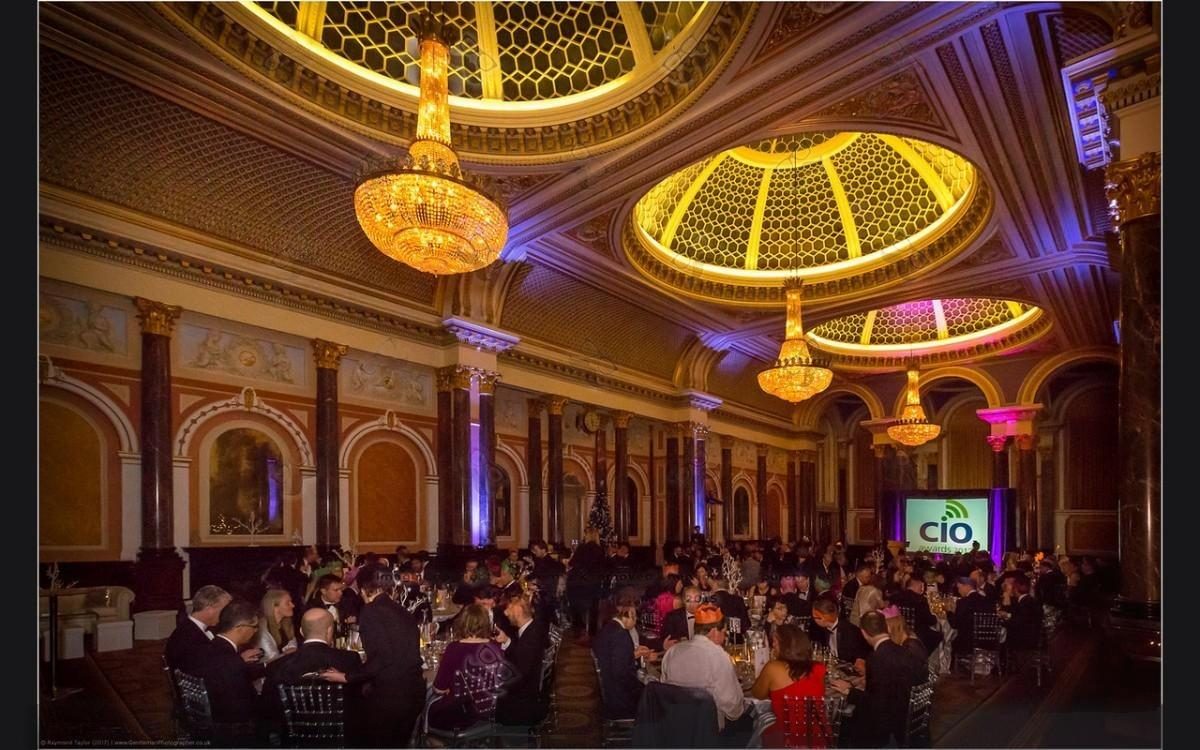 Wide view of the gilded domed banqueting hall with guests seated at round tables