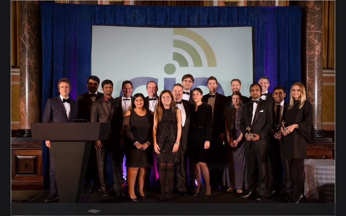 The 2017 award winners lined up on stage with their trophies in front of a lit CIO backdrop